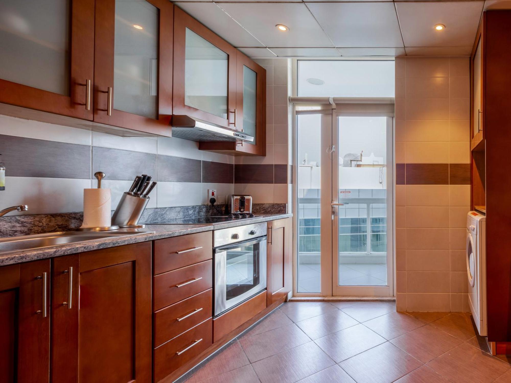 Two-Bedroom Apartment Kitchen & Balcony – Monthly