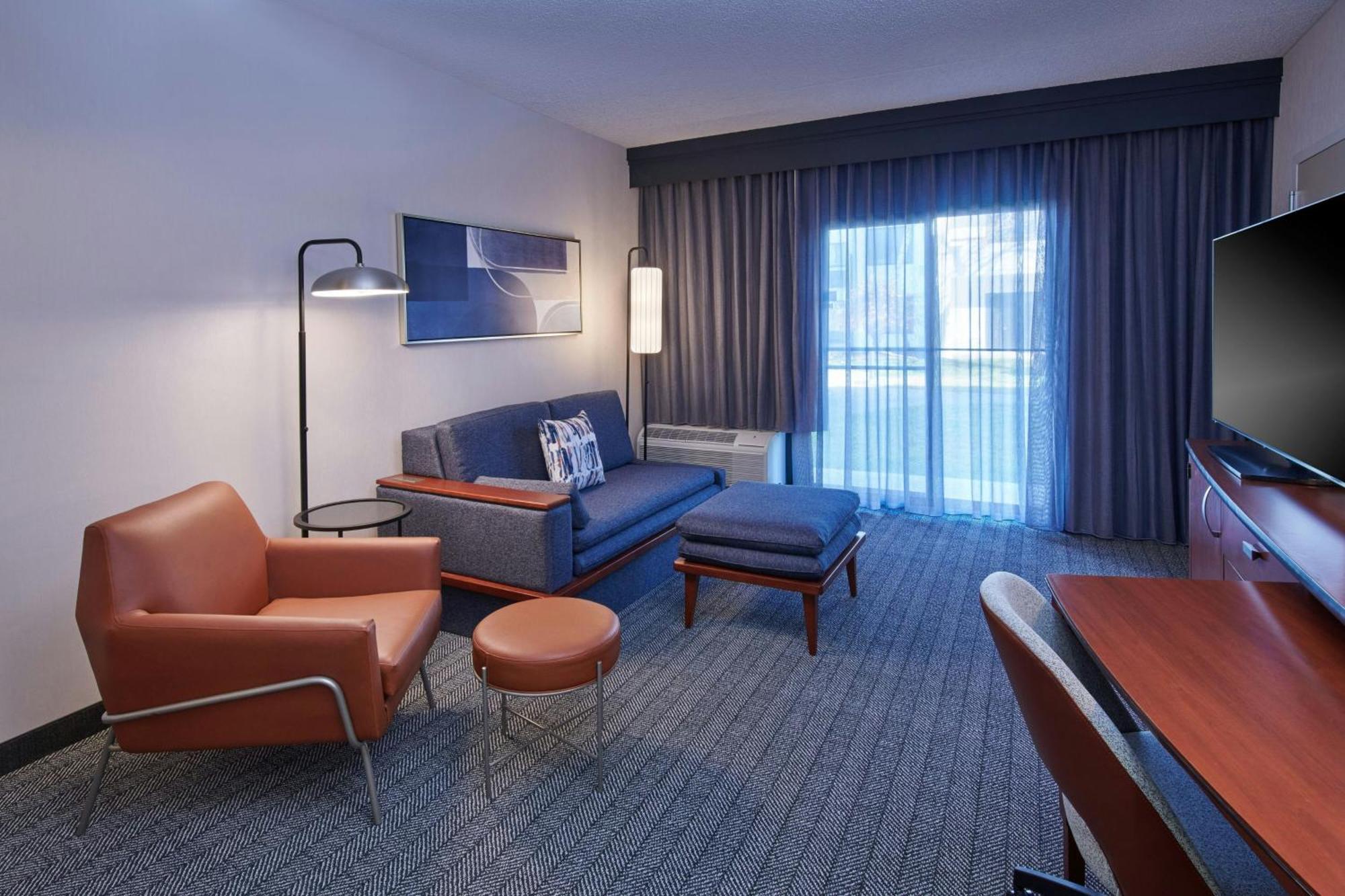 One-Bedroom King Suite Sofa Bed Adapted Tub Courtyard View Mobility Hearing Accessible